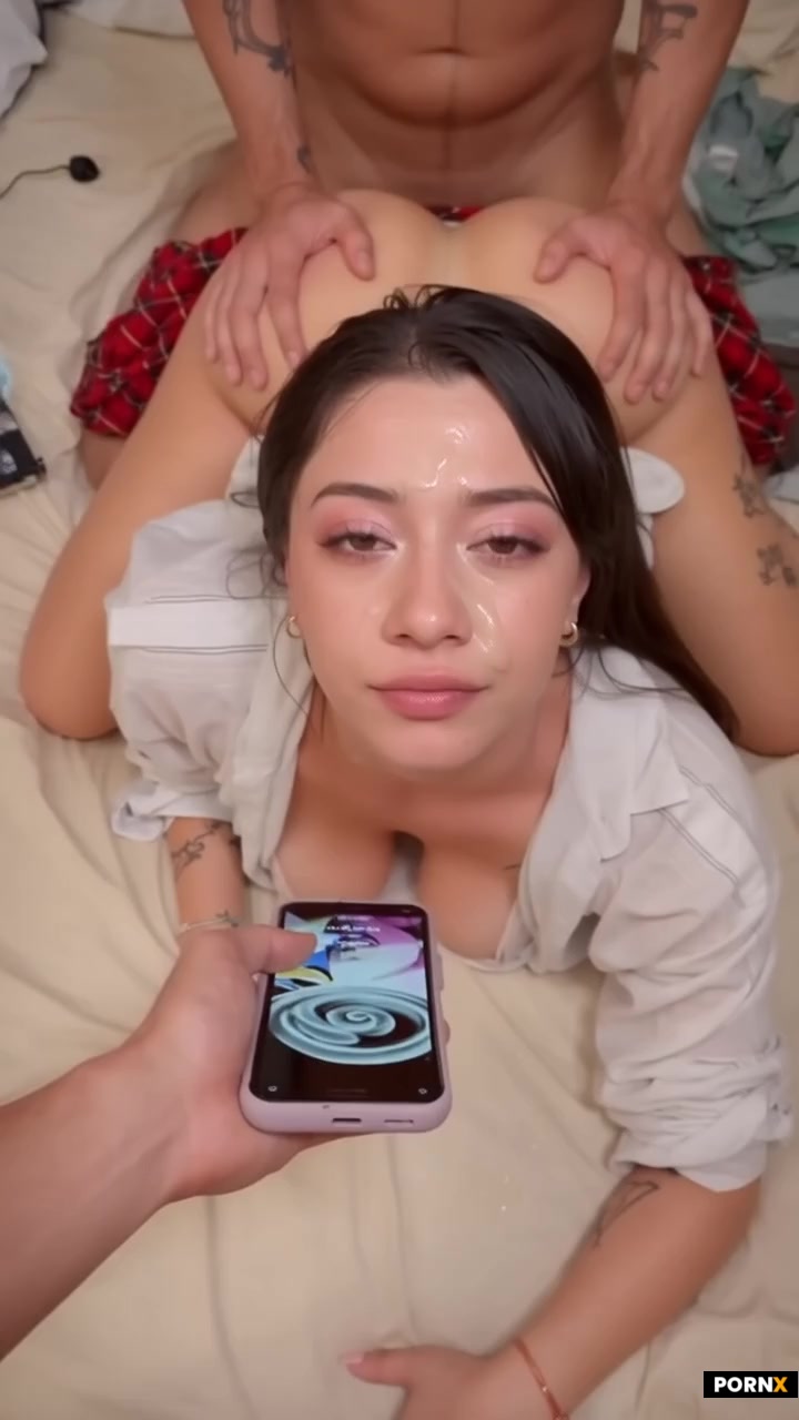 A cute Japanese woman is looking up directly at a phone screen